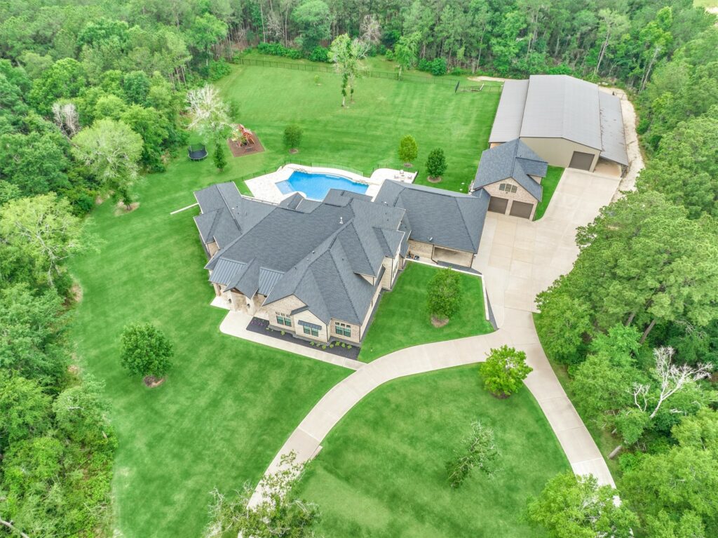 | the mckellar group Drone Shot of a Large Gated Community Home with a Pool