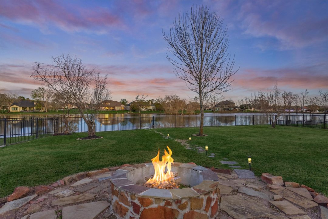 39 039 18904 w grand pine cir | the mckellar group a Firepit in the Backyard at Sunset Overlooking the Lake