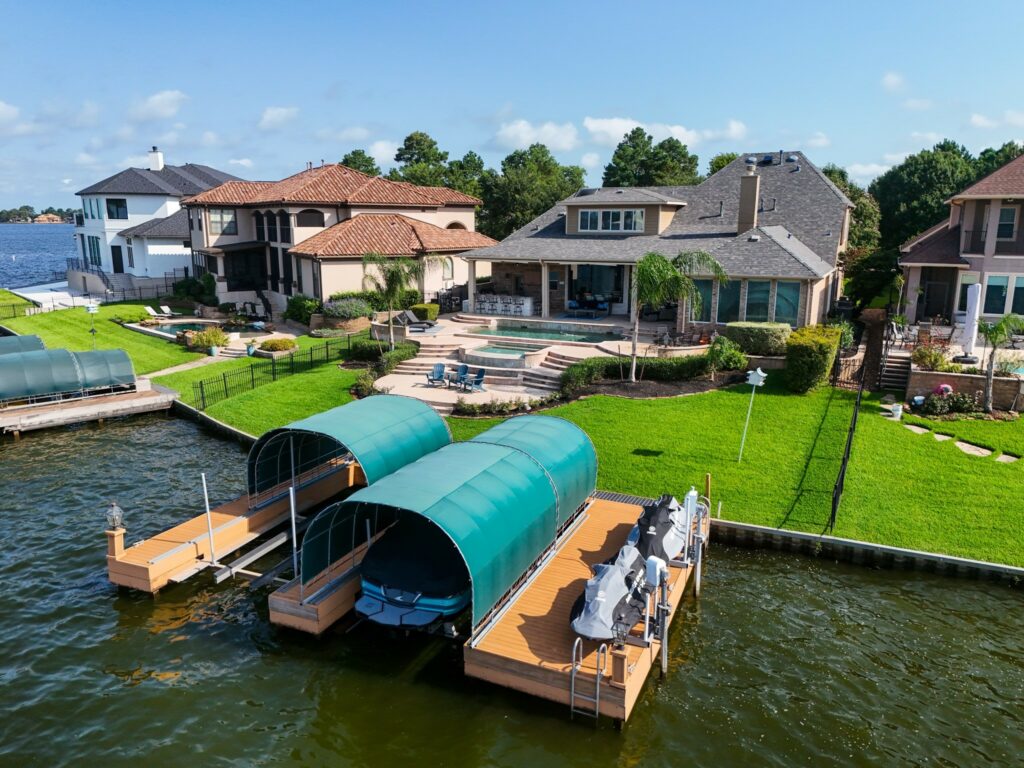 | the mckellar group Aerial View of Boat Docks Behind a Lake House on Lake Conroe