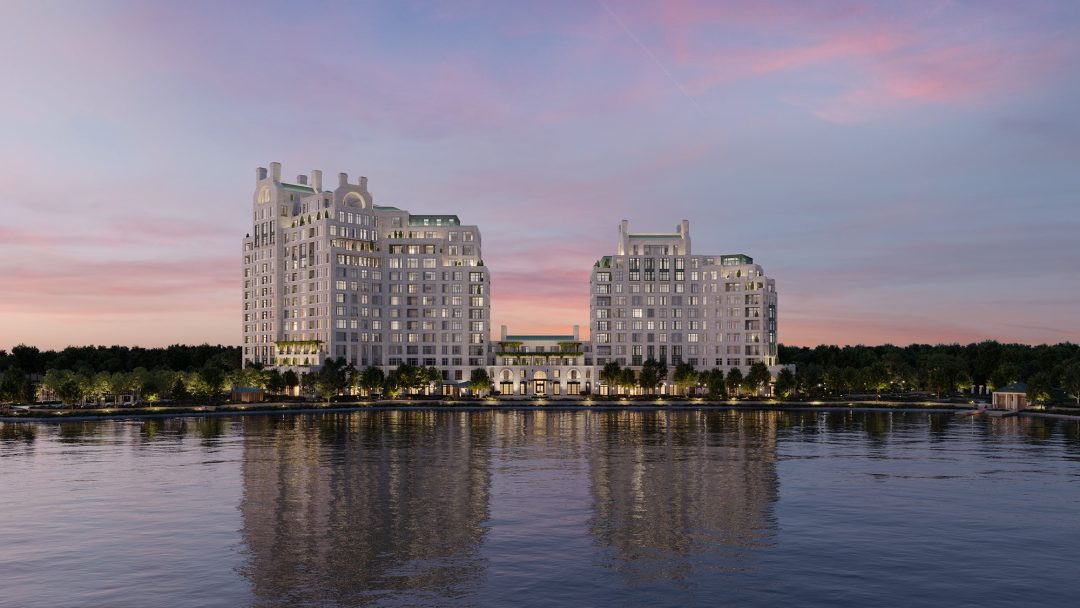Wide Shot of Luxury Condos Along the Lake Lit Up Before Sunset