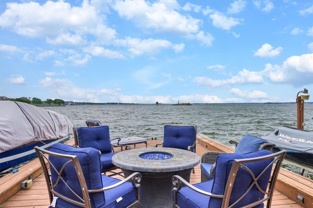 Patio Chairs Around a Fire Pit on the Dock with the Lake in the Background