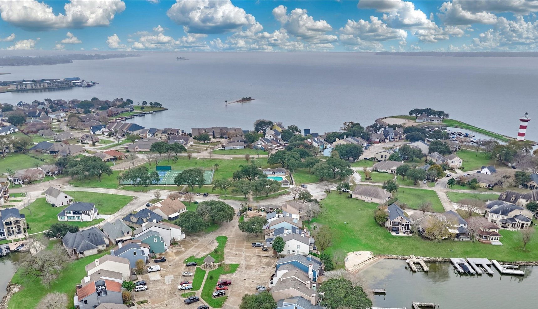 Aerial View of a Lake Conroe Neighborhood with Condominiums Townhouses and a Tennis Court in the Background