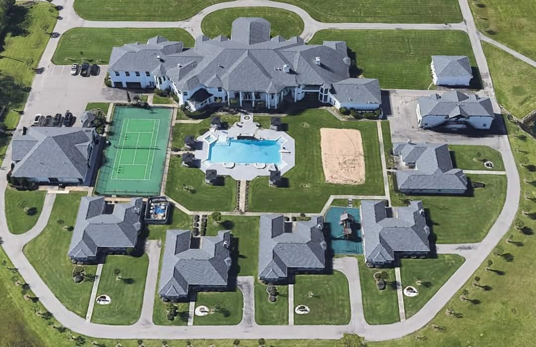 Aerial View of a Multi Million Dollar Multi family Property with a Tennis Court Pool and Volleyball Court