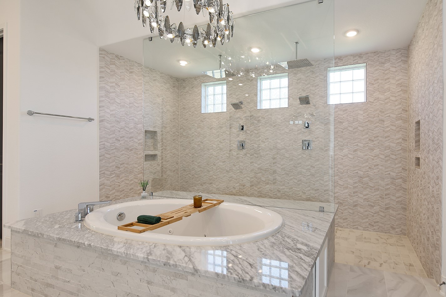 Bright Luxurious Resort Vacation Style Bathroom with a Garden Tub Large Standing Shower and Chandelier
