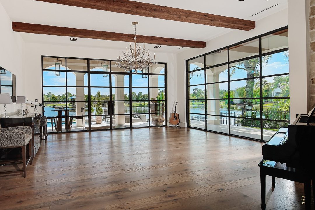| the mckellar group Interior of a Spacious Living Room with Large Floor to Ceiling Windows Letting Light In