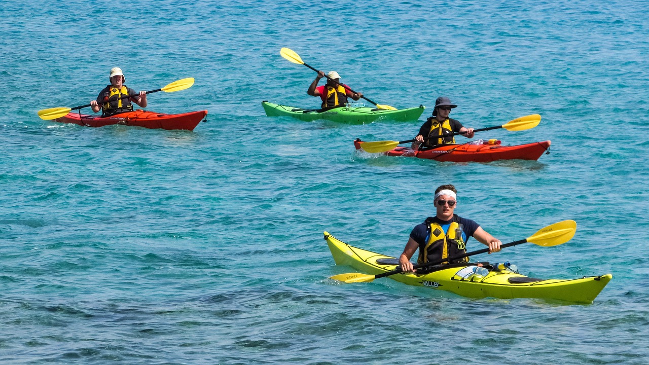 | the mckellar group a Group of Four Friends Kayaking in Blue Water on the Lake