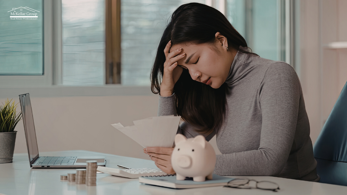 | the mckellar group Woman Reviewing Finances with Concern