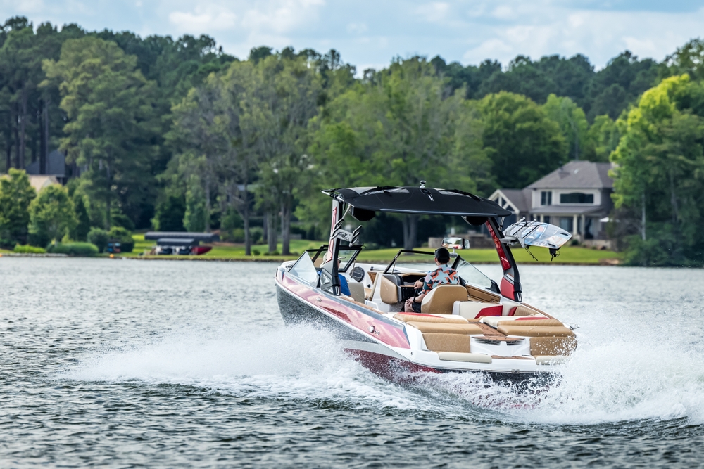 Boatersonredwakeboardskiboatenjoyingsummerdayon | the mckellar group Boating with Family on Lake Conroe Texas