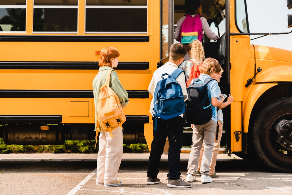 Summerholidaysareover Schoolchildrenkidspupilsgroupofmixedrace | the mckellar group Kids Entering School Bus in Conroe Texas