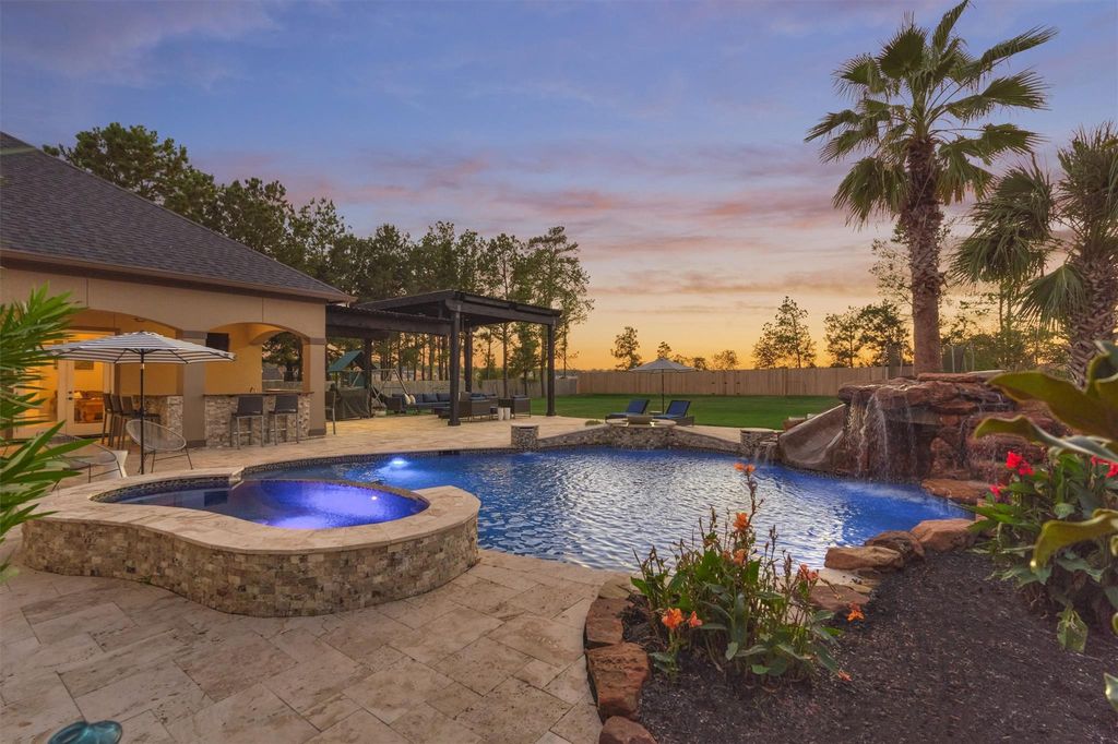 755979921 | the mckellar group Backyard Pool with Spa Stone Patio Pergola and Palm Trees at Sunset
