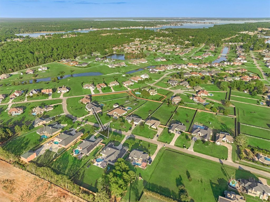 756179912 | the mckellar group Aerial View of a Suburban Neighborhood a Property is Outlined in Orange with a White Arrow Pointing to It